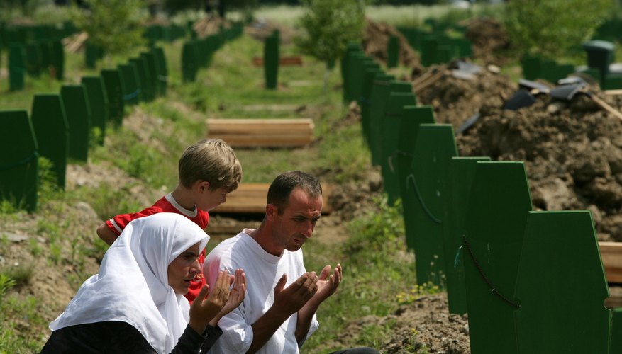 Bosnians remember victims at a mass burial site.