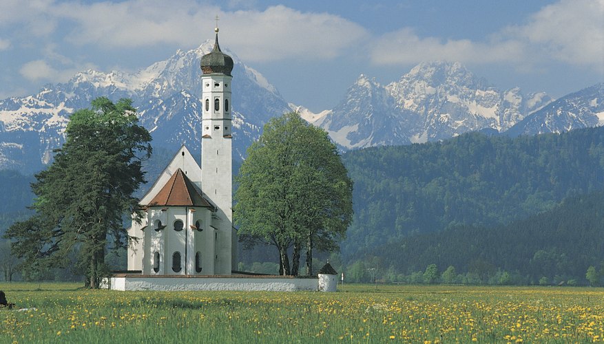 A church surrounded by trees in a field.