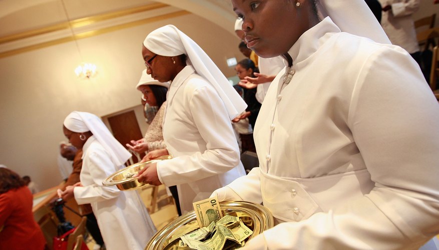 Nation of Islam followers collect the offering after a speech by Louis Farrakhan at the Mosque Maryam in Chicago.a.