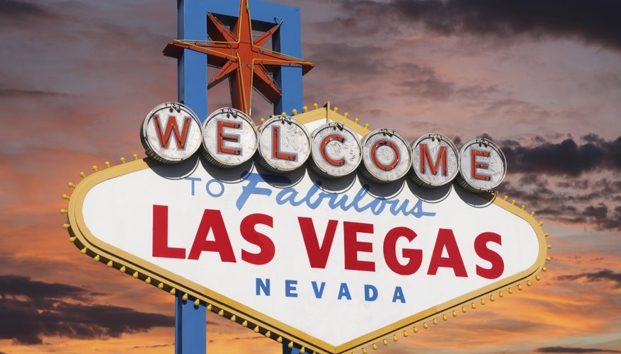 A welcome to Las Vegas sign at sunset.