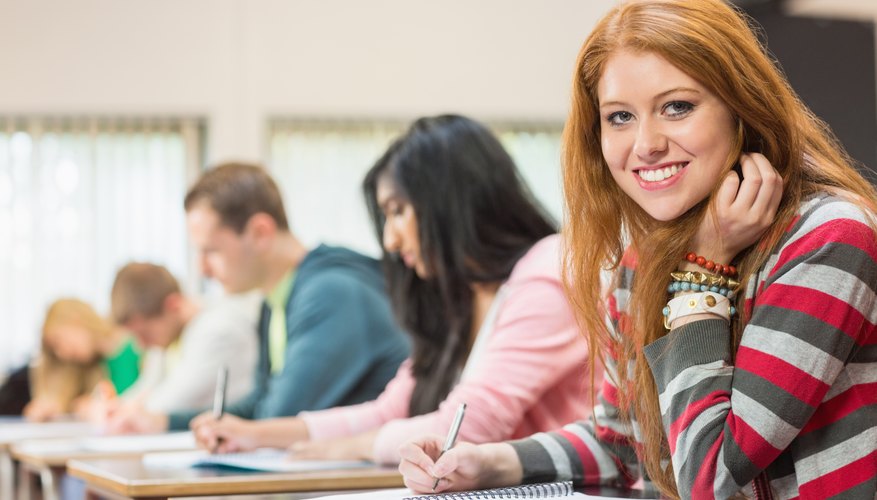 Students writing in notebooks in classroom