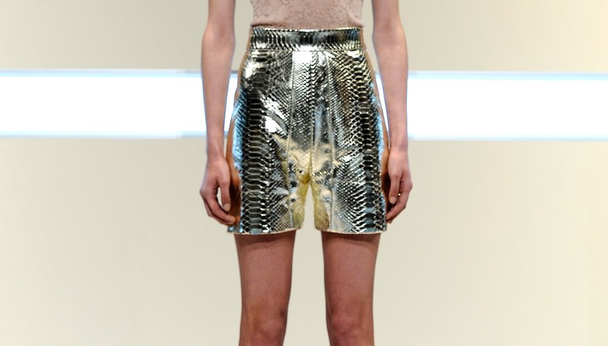 A model at Matheiu Mirano sports a beige top with a metallic skirt for an ultra-chic ensemble.