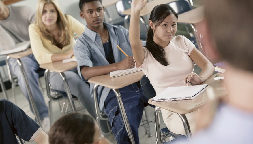 Student raising her hand in classroom