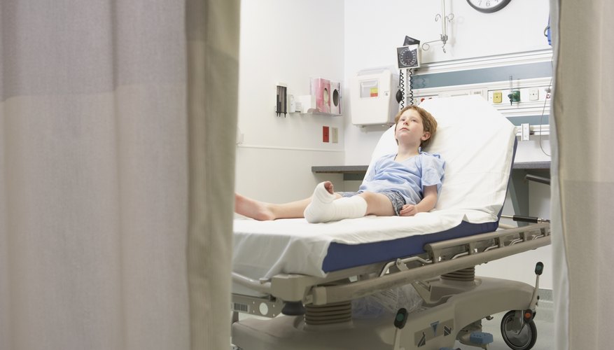 Child in hospital bed with broken leg cast.