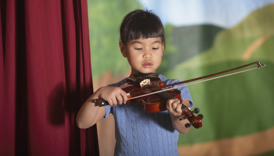 Young child playing the violin.
