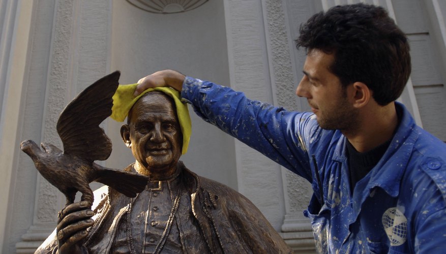 In Istanbul a worker cleans a statue of Pope John XXIII, father of Vatican II.