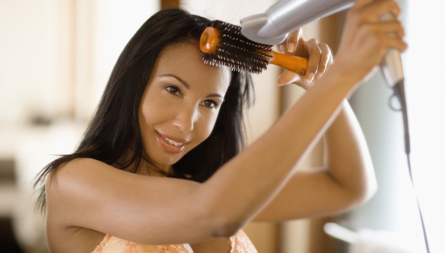 Boost volume by brushing hair upwards as you blow dry.