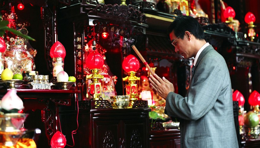 Chinese man paying respects to his ancestors
