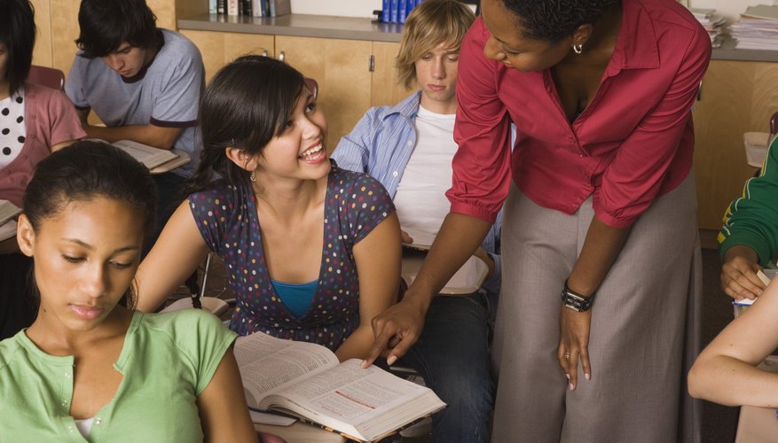 A teacher assists a student in the classroom