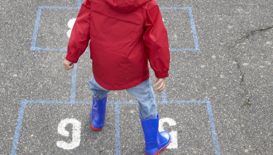 Little girl playing hopscotch