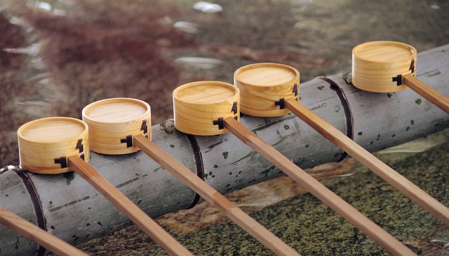 Shinto followers purify themselves with sacred water before entering a shrine.