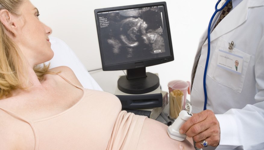 A diagnostic medical sonographer images a patient to determine her baby's health.