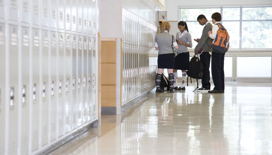 A group of school children standing by their lockers.
