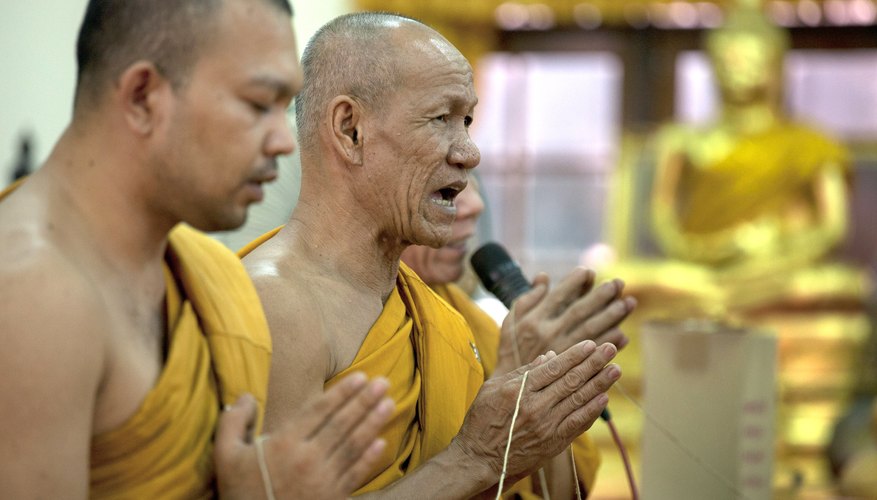 Sangha, infusing the white thread with their prayers.