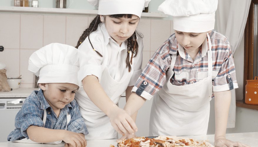 Young children making a pizza
