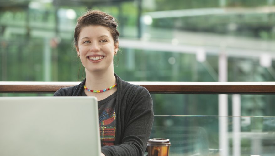 A college student working from her laptop on campus.