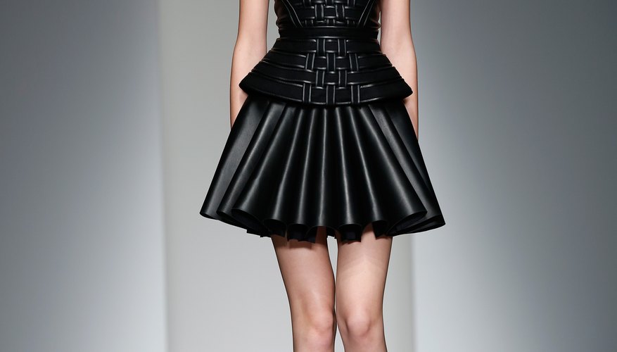 A model walking the David Koma show during London Fashion Week creates lower-body curves with a full skirt.