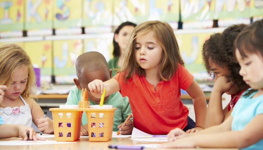 Group of kindergarteners working on craft in classroom