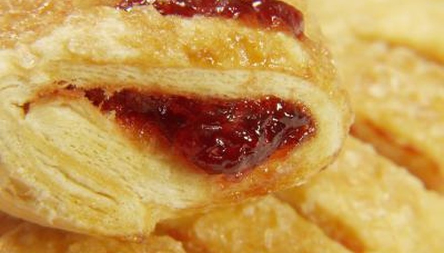 Puff pastry filled with fruits may sometimes escape through the scored lines.