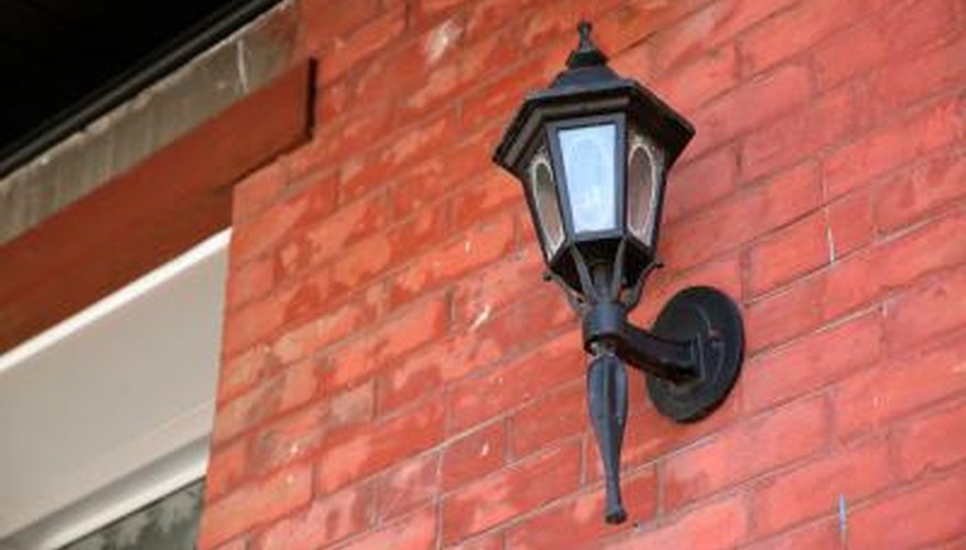 The decorative portions of your porch light may have hidden bolts.
