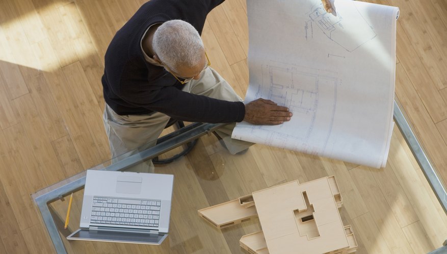 Overview shot of an architect looking at plans.