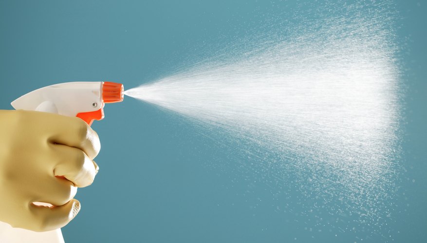 Use a spray bottle as a tool for fashion design experiments.