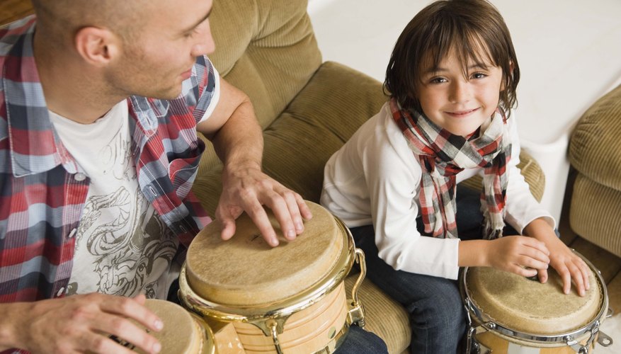 The teacher uses a drum to create a rhythm and asks children to make their feet do what the drum does.