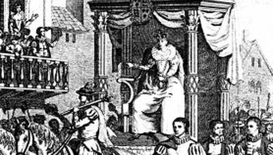 Elizabeth I rides in a procession in what may be a type of horse-drawn carriage.