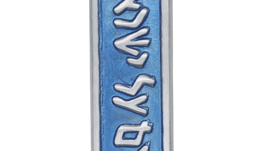 The Jewish mezuzah hangs on doorposts as a sign of faith.