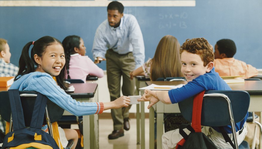 A teacher and his young students in a classroom