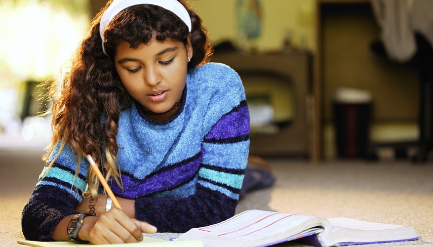Sixth grade student working on homework at home.