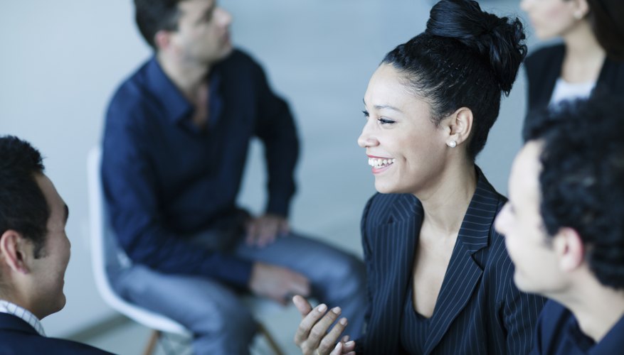 A group of young adults are discussing a common subject of interest