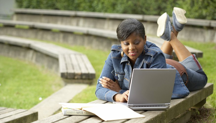 Student working outside on laptop