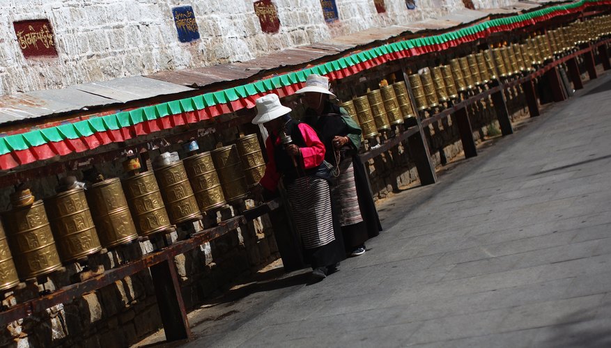 Turning an engraved prayer wheel earns merit for all sentient beings.