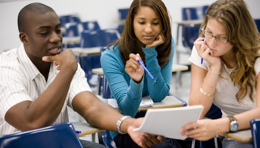 College students having a group discussion in classroom.