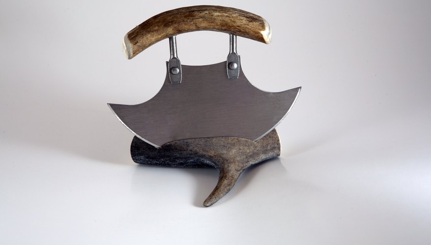 A historical ulu knife on display in a museum.