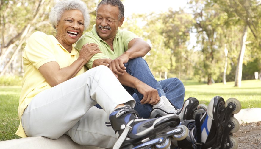 Mature couple wearing rollerblades.