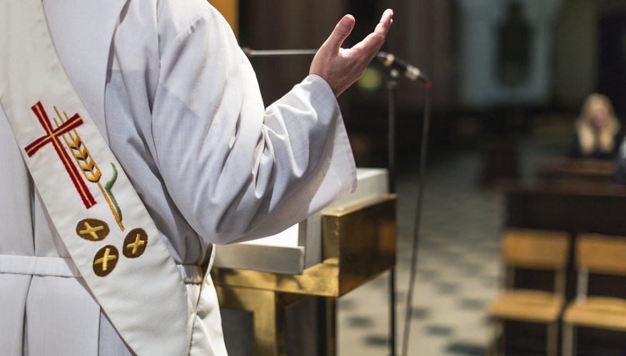 Catholic deacon standing in front of church pews