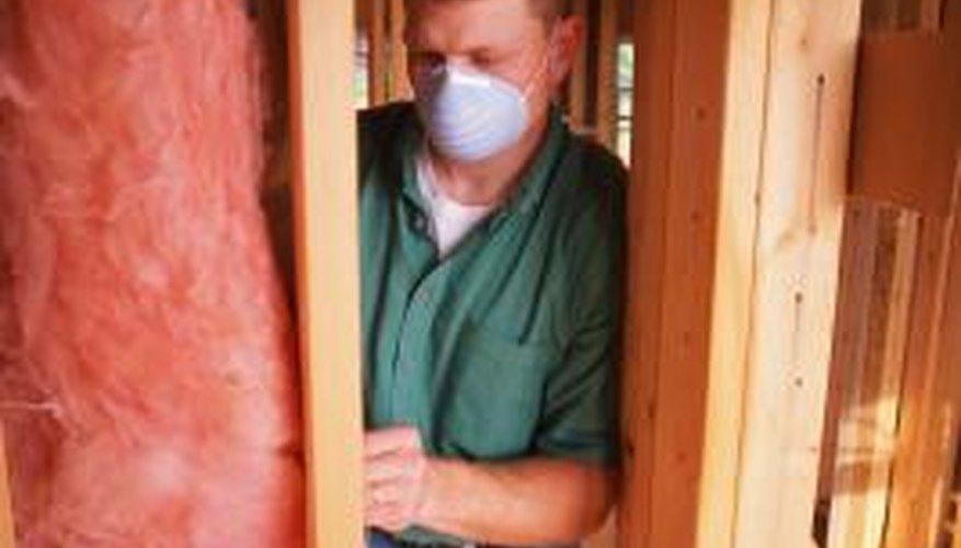 Wearing a dust mask while working with fibreglass insulation provides protection against inhaling or swallowing particles.