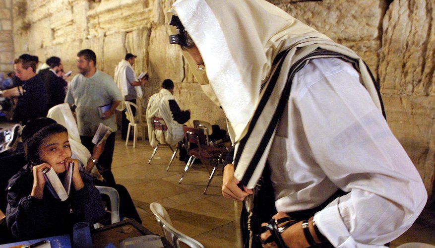 Men don ritual phylacteries at the Wailing Wall.