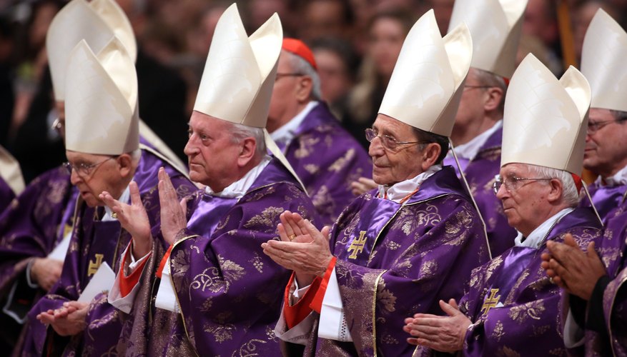 Catholic clergy wear purple robes in honor of Lent and Christ's crucifixion.