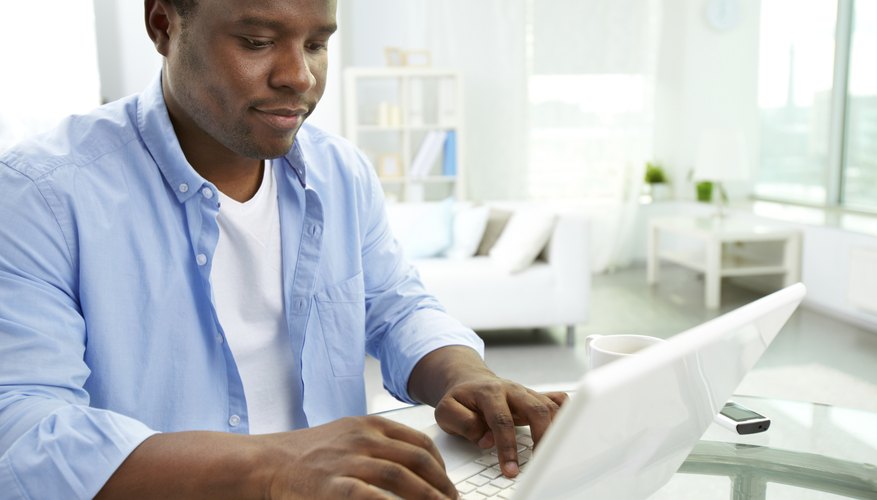 Student typing on laptop