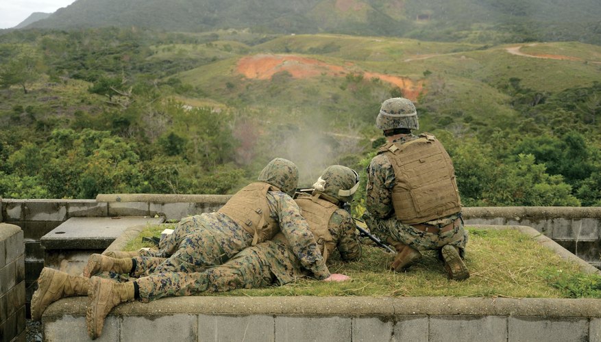 Marine infantry watching hills in the distance.