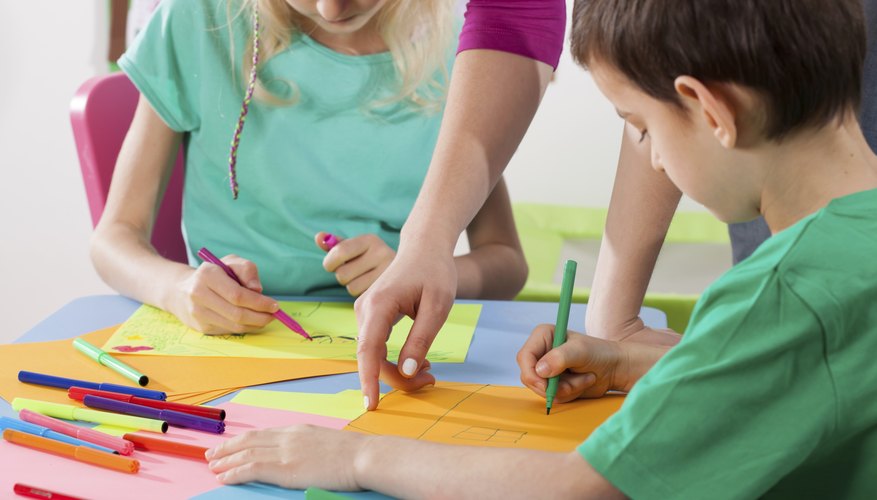 Close-up of young children working on crafts