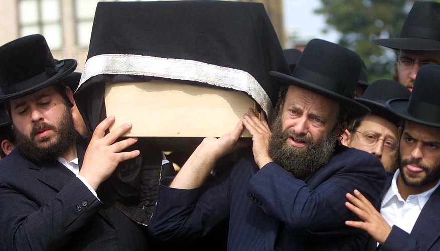 Orthodox Jews carry a traditional, unadorned pine casket.