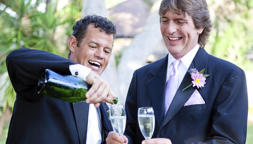 A gay couple is pouring champagne to celebrate their marriage.