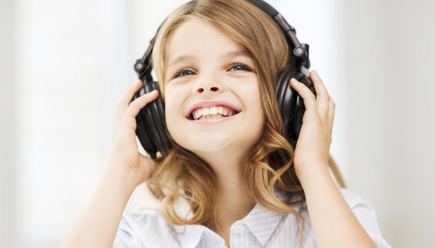 Young child listening to music on headphones