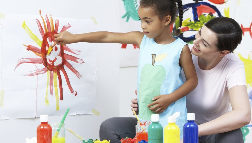 A kindergarten student doing arts and crafts.
