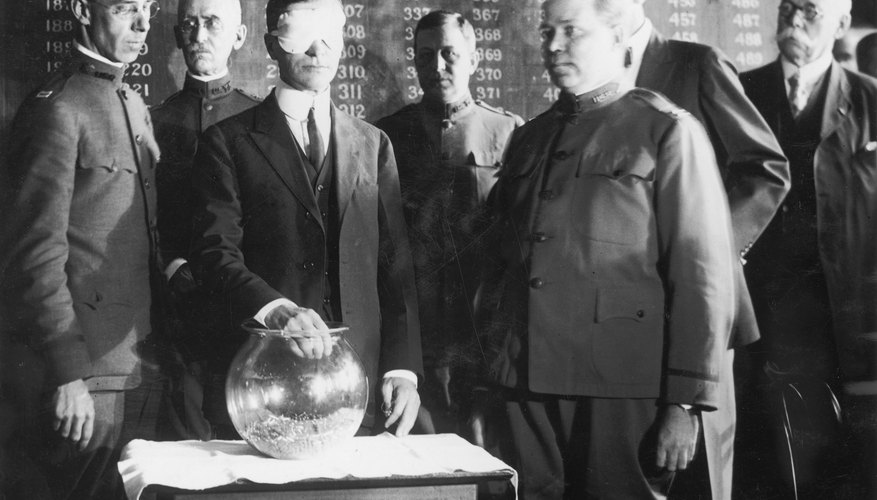 Blindfolded Secretary of War Newton Baker pulls name from glass bowl at the start of World War One