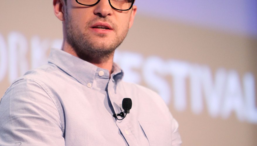 Justin Timberlake's newsboy cap, thick-framed glasses and fitted button-up sum up the geek chic style.